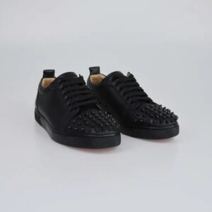 A pair of Christian Louboutin Louis Junior Spikes Trainers featuring black calf leather